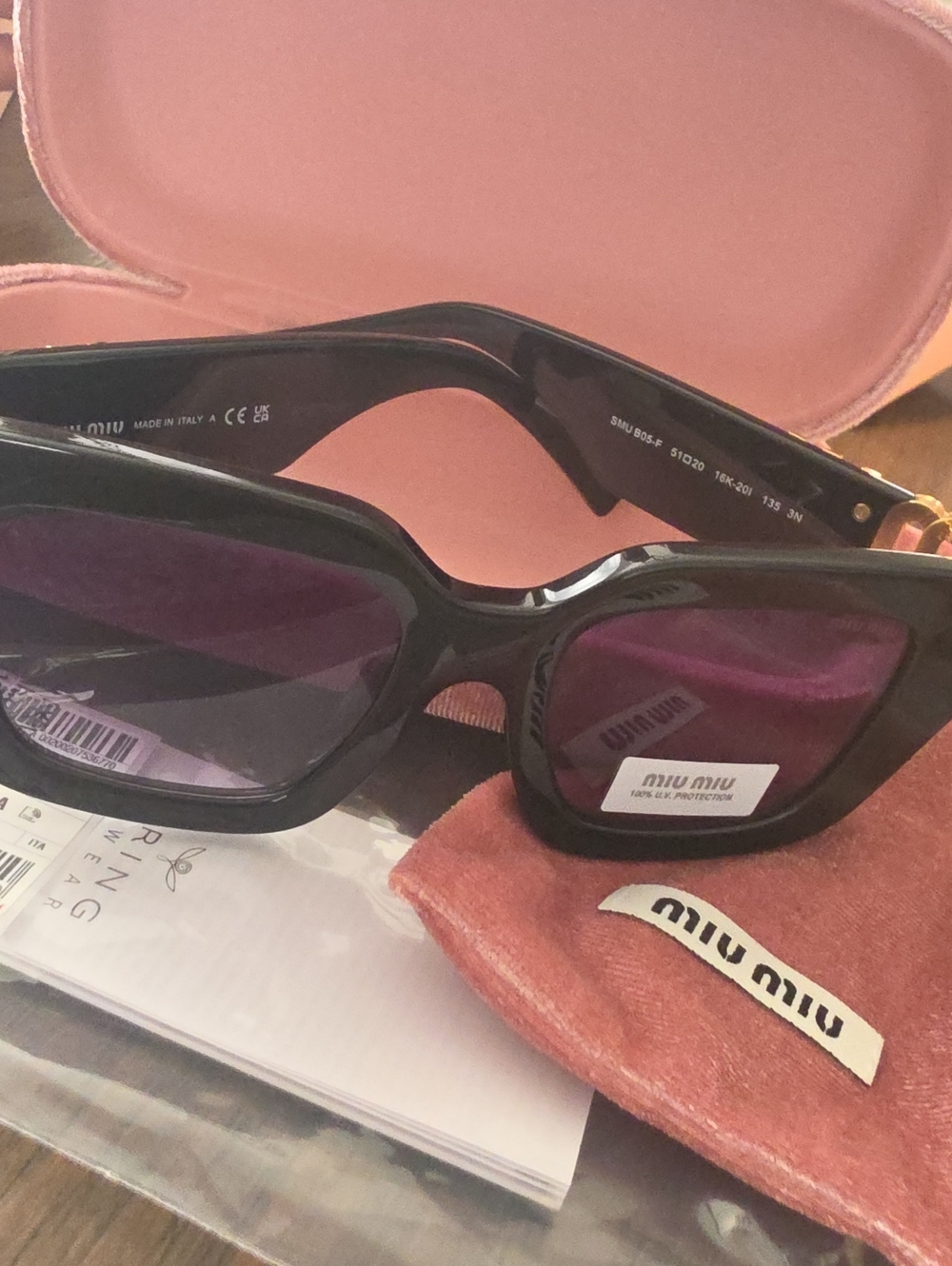 Miu Miu Glossy Black Frame Sunglasses with Purple Lenses